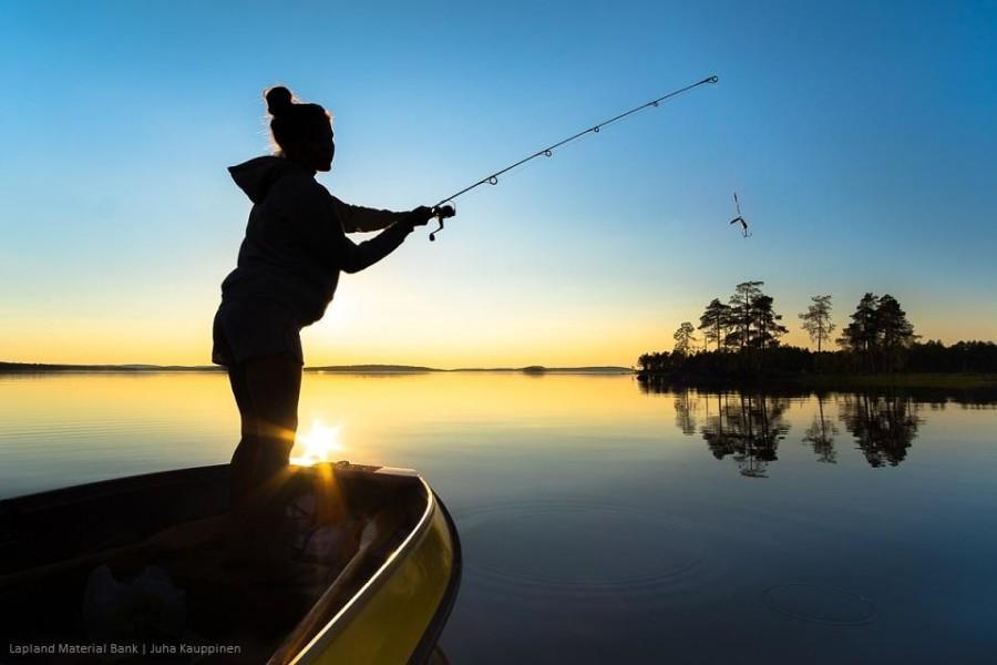 Girl fishing in Lake Inari.