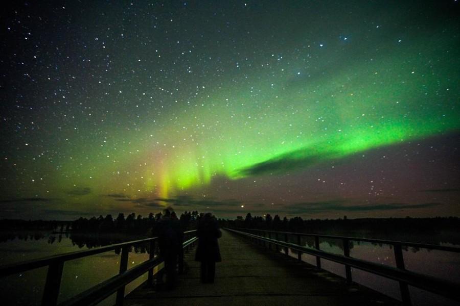 northern lights over the bridge of Paatsjoki nellim